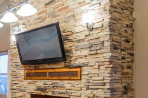 Big Project: Stone Wall with Built In Fireplace | blowingawayoutwest.com - How we built a jaw dropping fireplace with built in TV and hidden electronics #diyproject #diyfireplace #howtobuild #stackedstonewall